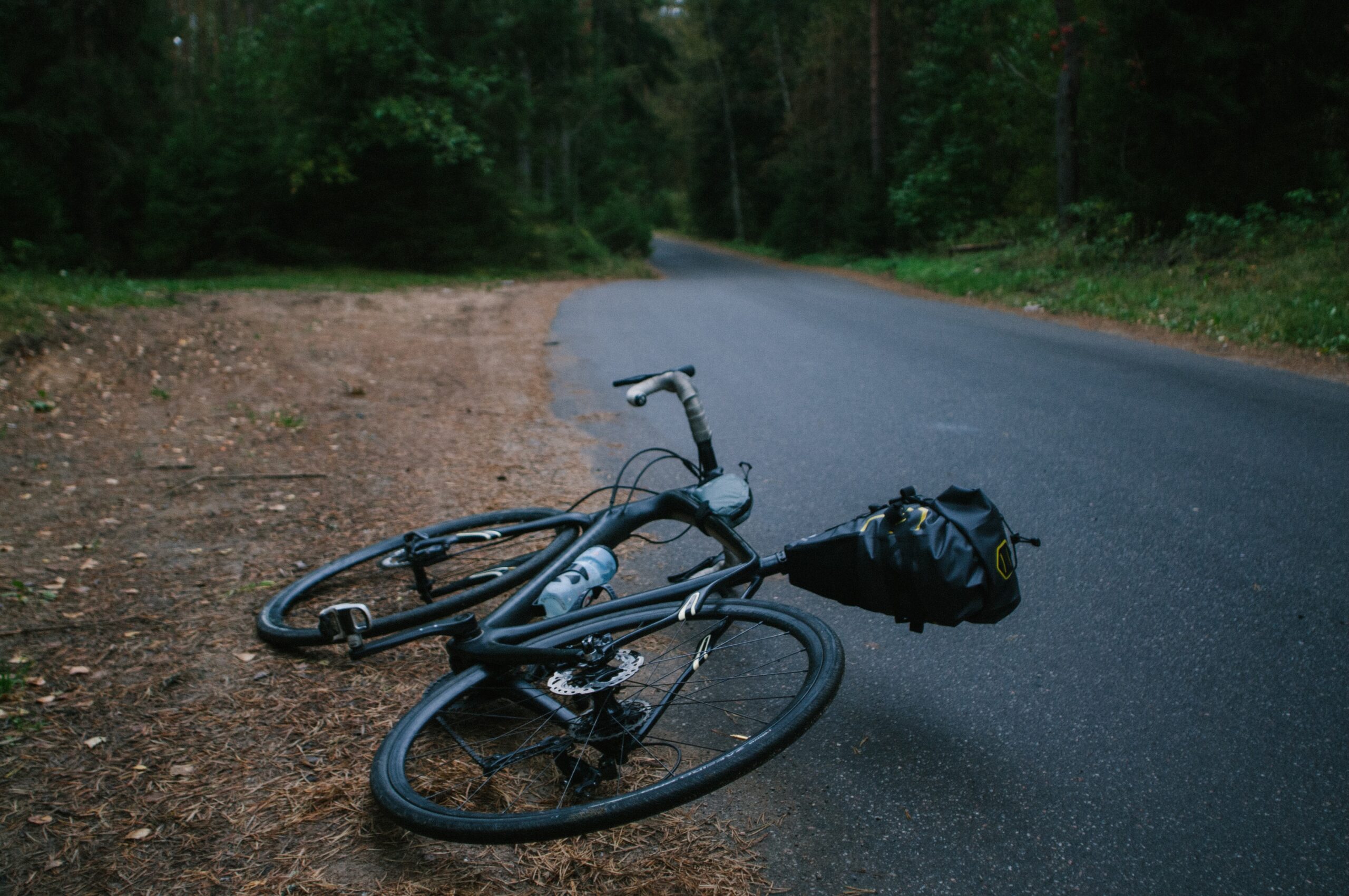 A bike laying on the side of a road, representing claims for loss of competitive advantage in personal injury cases