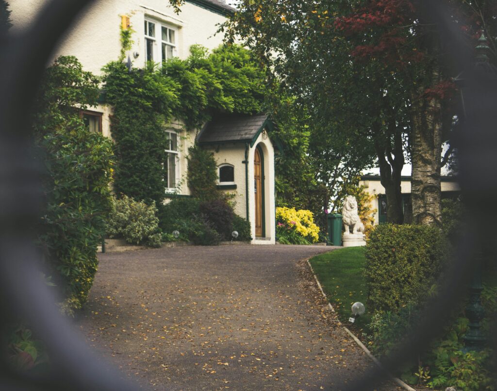 The front entrance of a house viewed through a fence, representing a real estate breach.
