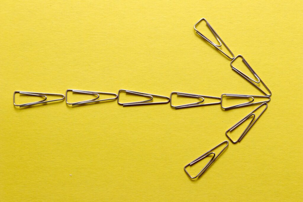 Silver paper clips on yellow textile representing a guide to Ontario injunctions.