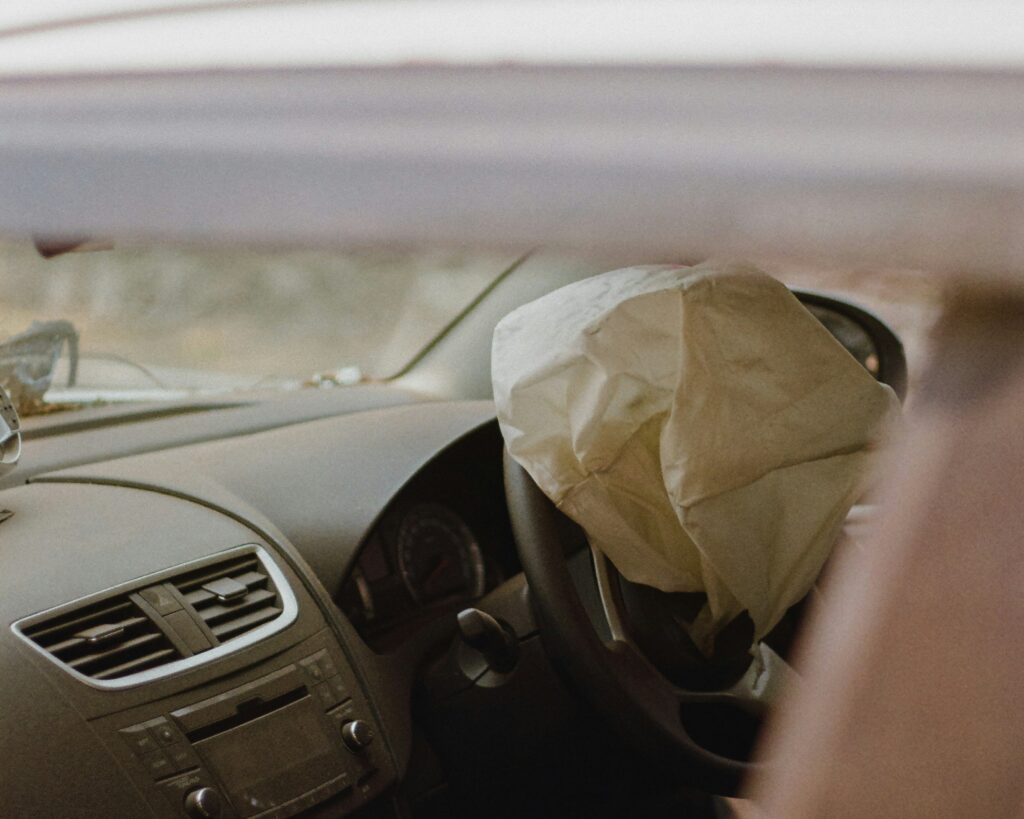 A car's airbag deployed, representing how faulty airbags can cause or worsen crash injuries.