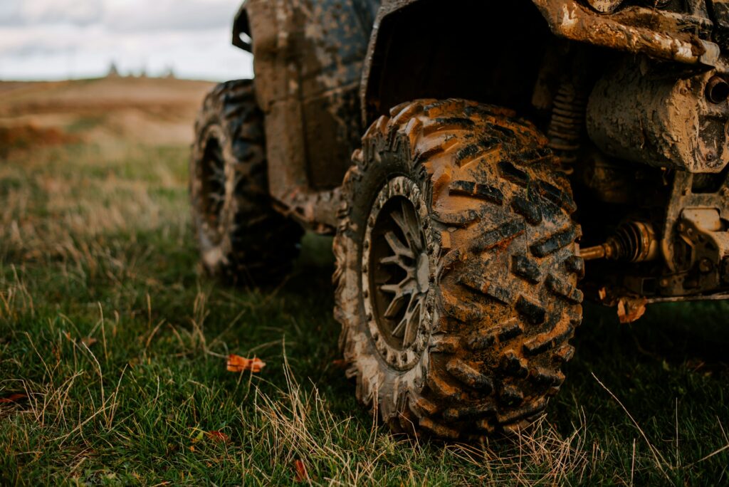 A close-up photo of muddy ATV tires, representing ATV accidents in Ontario